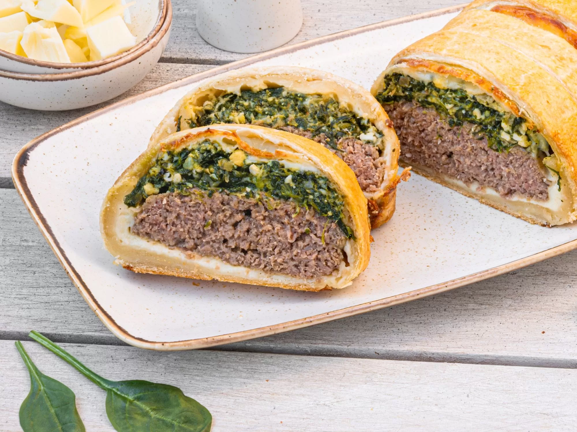 Meat roulade with spinach and egg in puff pastry