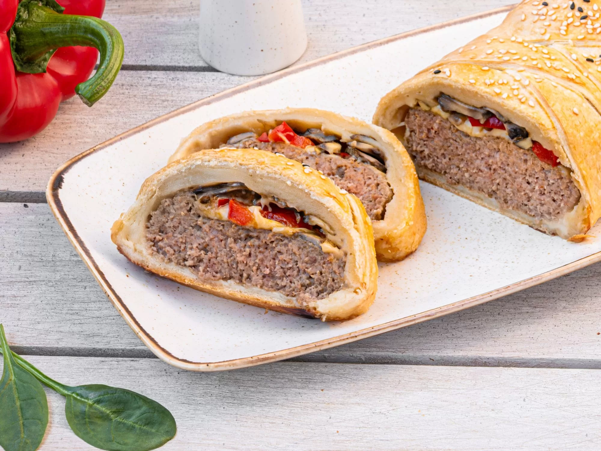 Meat roulade with peppers and mushrooms in puff pastry