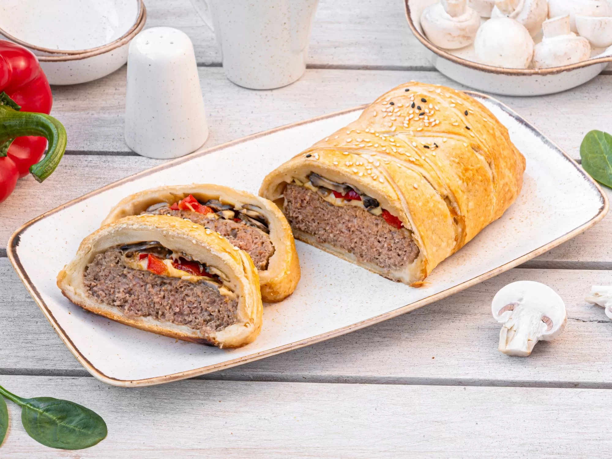 Meat roulade with peppers and mushrooms in puff pastry
